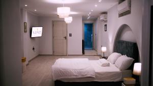 a bedroom with a large white bed in a room at Madina Boutique Hotel in Luxor