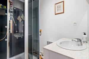 a bathroom with a sink and a shower at L'instant présent in Hautot-lʼAuvray