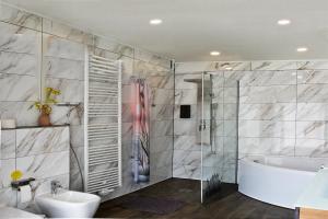 a bathroom with a shower and a tub and a sink at Martin Ferienhaus in Burg bei Magdeburg +43 photos