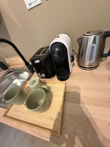 a counter top with a coffee maker and cups on it at A CA' da 8 e Jacky in Casalecchio di Reno