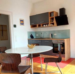 a kitchen with a table and chairs in a room at Historisches Stadthaus Schwentine in Eutin +4 photos