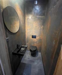 a bathroom with a sink and a toilet and a mirror at Apartmán Natalka7 in Bartovice