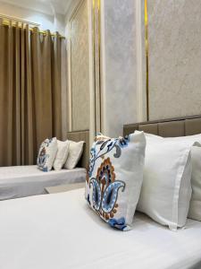 a bedroom with two beds with pillows on them at ANNUR Boutique Hotel in Samarkand +99 photos