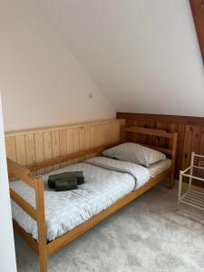a bedroom with a bed with a wooden frame at agroOBERIBA in Płatkownica