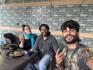 a group of three people sitting at a table at House of Brahma Kasol in Kasol +107 photos