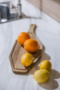 a bunch of oranges and lemons on a cutting board at Poem Suites by Airnest in Las Palmas de Gran Canaria