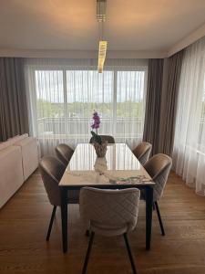 a dining room with a table and chairs at Luxury Oasis in the Heart of the City in Druskininkai