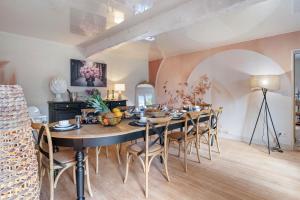a dining room with a large table and chairs at L'instant présent in Hautot-lʼAuvray