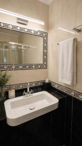 a bathroom with a white sink and a mirror at Ammos Boutique Rooms-Seafront Stay in Elafonisos in Elafonisos +33 photos