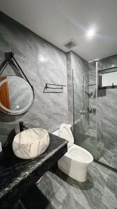 a bathroom with a shower and a toilet and a sink at Tuần Châu HQT in Ha Long