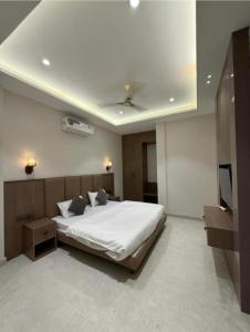 a bedroom with a bed and a flat screen tv at Hotel sky inn in Jalandhar +4 photos