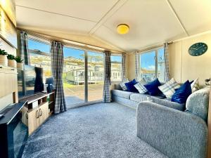 a living room with a couch and a tv at Dale 12 in Burgh Island