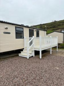 a rv with white risers and a porch at Dale 12 in Burgh Island