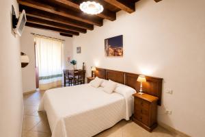 a bedroom with a bed and a table with a lamp at L'Antica Torre Caralis Holiday in Cagliari
