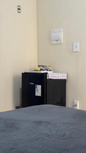 a room with a bed in a room with aperature at Na Ladeira Studio 02 in Rio de Janeiro
