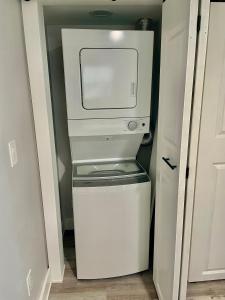 a refrigerator with a microwave in a small kitchen at Lil' Beach Getaway in Jacksonville Beach
