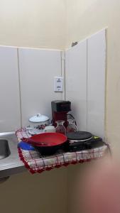 a shelf in a kitchen with pots and pans on it at Na Ladeira Studio 02 in Rio de Janeiro