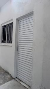 a white garage door on the side of a building at Na Ladeira Studio 02 in Rio de Janeiro
