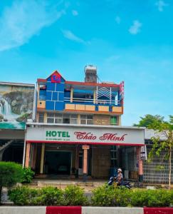 a hotel with a person on a motorcycle in front of it at Khách sạn Thảo Minh in Lagi