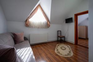 a living room with a couch and a window at Casa Toma in Sovata