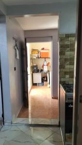 a room with a kitchen with a stove and a hallway at Hebergement Tamazight 2 in Tarrast