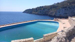 a swimming pool with a view of the ocean at Affitto nel cuore del Salento in Poggiardo