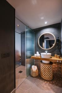 a bathroom with a sink and a mirror at Poem Suites by Airnest in Las Palmas de Gran Canaria