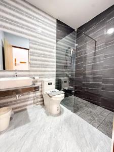 a bathroom with a toilet and a sink and a shower at Wansuk Chiangkhan in Chiang Khan +41 photos