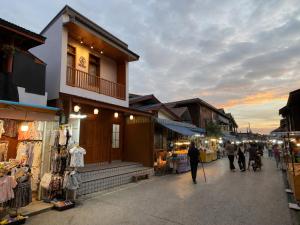 a group of people walking down a street in a market at Wansuk Chiangkhan in Chiang Khan