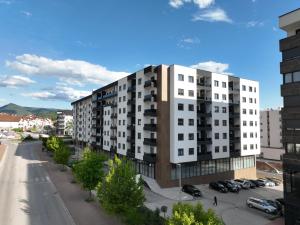 an apartment building in a city with a parking lot at Apartman Lady A2 Istočno Sarajevo in Vranješ