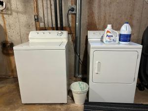 a white stove and a small refrigerator with a bottle of milk at Modern Queen St Duplex 4BRs in Charlottetown