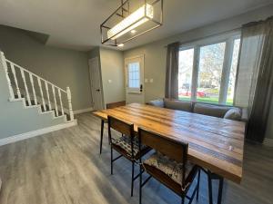 a dining room with a wooden table and chairs at Modern Queen St Duplex 4BRs in Charlottetown