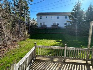 a wooden fence in front of a white house at Modern Queen St Duplex 4BRs in Charlottetown