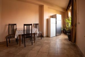 a dining room with a table and a refrigerator at Casa Toma in Sovata
