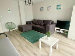 a living room with a couch and a table at Várhegy Vendégház in Fonyód