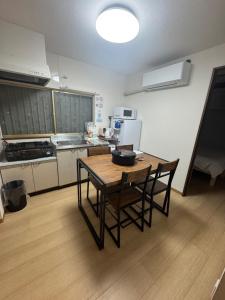 a kitchen with a table and chairs in a room at 羽憩館 Hakeikan KIX in Izumi-Sano +47 photos
