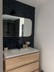 a bathroom with a sink and a mirror at Chez Firmin in Manhay