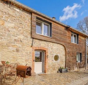 a brick house with a white door and windows at Chez Firmin in Manhay