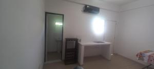 a white bathroom with a sink and a mirror at Juaky market y alojamiento in Garupá