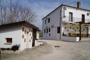 a white building with a balcony on the side at B e B LEMI in Ponte