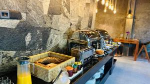 a buffet line with food on a table in a restaurant at Villa Rumassala Luxury Chalets Unawatuna in Unawatuna