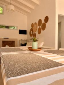 a room with white walls and a table at Cabañas Aires del Sur, con gran parque y pileta in Chascomús