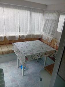 a small table in a room with a couch at Camping les sumacs in Combles
