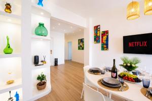 a dining room with a white table and chairs at You and the Sea in Savona