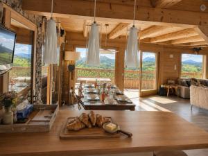 a living room with a table with bread on it at La Framboiseille - Chalet de Luxe avec Piscine Intérieure et Sauna - Vue Montagne in Manigod
