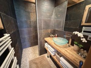 a bathroom with a sink and a shower at La Framboiseille - Chalet de Luxe avec Piscine Intérieure et Sauna - Vue Montagne in Manigod +36 photos