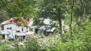 a white house with a red roof and trees at Casacresta in Carabaño +2 photos