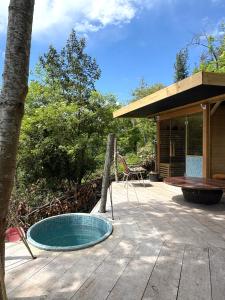 a small pool on a wooden deck with a house at Casacresta in Carabaño