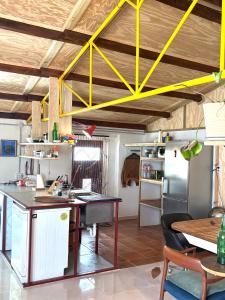 a kitchen with a table and a yellow ceiling at Casacresta in Carabaño