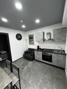 a kitchen and living room with a couch and a table at Dimora Deluxe in San Severo